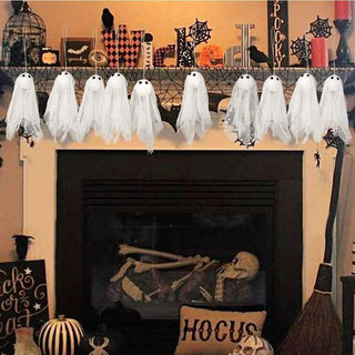 Hanging ghost decorations with white tulle covers and black eyes, group on strings