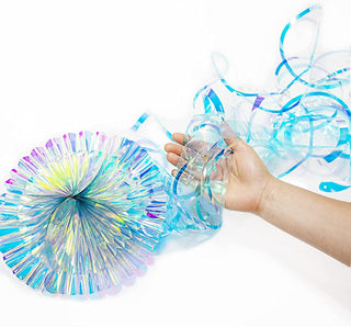 Hand holding iridescent purple-blue glitter jellyfish streamer decoration with cap