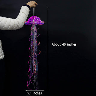 Hanging iridescent purple jellyfish decoration held for size, long ribbon tentacles