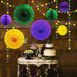Mardi Gras paper fans and honeycomb decorations in gold, purple, and green on strings