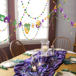 Mardi Gras mask and bead garland banner with purple, gold, and green masks near party table