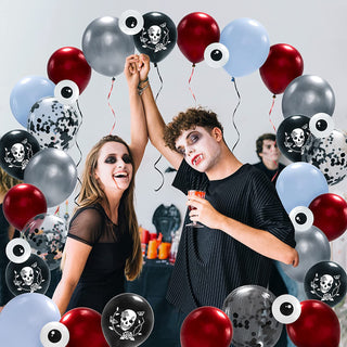 Cluster of skull-print Halloween balloons in red, silver, black, and light blue with white tips