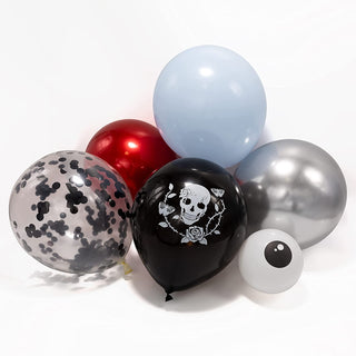 Close-up of skull-themed balloons in black, red, silver, light blue, and confetti print