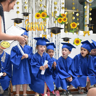 Graduation banner set with sunflower garlands and gold tassels, includes Congrats Grad text