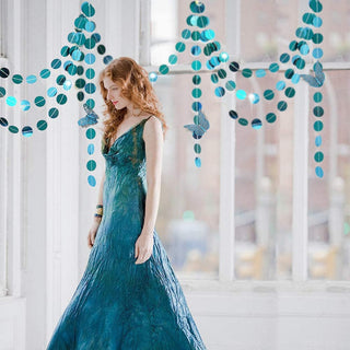 Teal and blue glitter circle garland draped in a loop pattern
