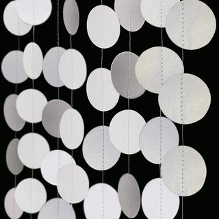 Pearl white circle dot garland with overlapping round discs on hanging strings, close-up