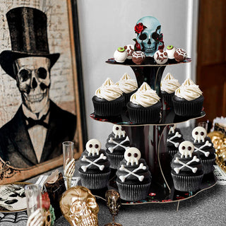 3-tier skull cupcake stand with red rose topper, holding white icing cupcakes